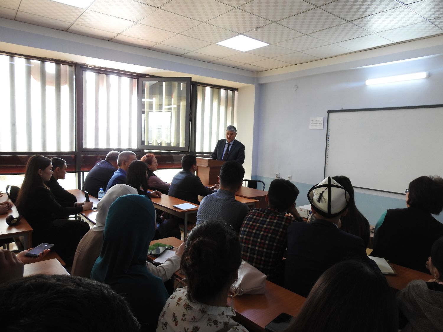 On 26th of March, 2019, on the occasion of the 75th anniversary of the formation of the Ministry of Foreign Affairs of the Kyrgyz Republic, an open lecture for students of the Faculty of International Relations of Osh State University was organized by the Plenipotentiary Representative of the Ministry of Foreign Affairs of the Kyrgyz Republic in Osh, Jalal-Abad and Batken regions.
During the lecture, Kaldarali Mamataliyev the Deputy Head of the Plenipotentiary spoke about the history of the formation and development of the diplomatic service of Kyrgyzstan, the activities of the Ministry of Foreign Affairs of the Kyrgyz Republic and the Plenipotentiary, as well as the priorities of the country's foreign policy.
In the framework of the lecture, students showed interest in the basic qualities of a modern diplomat, competitions held by the Ministry for filling vacant positions, as well as practical training opportunities in the structures of the Ministry. 
The lecture was attended by members of the Plenipotentiary, teachers of the faculty, as well as students of the faculty. 
Students attended this lecture with interest and were able to get answers to all their questions.

